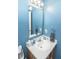 Bright bathroom featuring a single sink vanity and blue walls at 9215 Stones Bluff Pl, Indianapolis, IN 46113