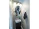 Compact powder room features a stylish pedestal sink and modern fixtures at 9215 Stones Bluff Pl, Indianapolis, IN 46113