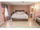 A spacious bedroom with a wooden bed frame and an ensuite bathroom at 9215 Stones Bluff Pl, Indianapolis, IN 46113