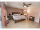Large bedroom with wood-look flooring, ceiling fan and ensuite bathroom at 9215 Stones Bluff Pl, Indianapolis, IN 46113