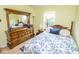 Bedroom with patterned bedding, a large dresser, and natural light from the window at 9215 Stones Bluff Pl, Indianapolis, IN 46113