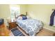 Inviting bedroom featuring a bed with stylish patterned bedding and a nightstand at 9215 Stones Bluff Pl, Indianapolis, IN 46113