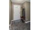 Entryway featuring neutral walls, tiled floor, and coat rack with storage for organized living at 9215 Stones Bluff Pl, Indianapolis, IN 46113