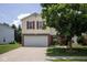 Home with attached garage, brick and siding exterior, and manicured lawn, under a partly cloudy sky at 9215 Stones Bluff Pl, Indianapolis, IN 46113