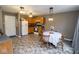 Eat-in kitchen with wooden cabinets, modern appliances, and a dining table set for a cozy meal at 9215 Stones Bluff Pl, Indianapolis, IN 46113