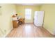 Bright eat-in kitchen featuring laminate flooring, a window, and white appliances at 9215 Stones Bluff Pl, Indianapolis, IN 46113