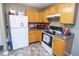 The eat-in kitchen features a white refrigerator, microwave and a white range at 9215 Stones Bluff Pl, Indianapolis, IN 46113