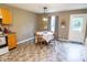 Cozy eat-in kitchen features an updated light fixture, dining table, and access to the backyard at 9215 Stones Bluff Pl, Indianapolis, IN 46113