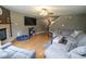 Comfortable living room with a fireplace, TV and ceiling fan at 9215 Stones Bluff Pl, Indianapolis, IN 46113