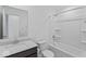 Well-lit bathroom featuring a bathtub-shower combo and modern vanity with granite countertops at 10107 Camp Creek Way, Indianapolis, IN 46229