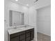 Bright bathroom featuring a double sink vanity with granite countertops and a large mirror at 10107 Camp Creek Way, Indianapolis, IN 46229