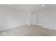 Empty bedroom featuring carpeted floors, white walls, and a ceiling light, with access to a hallway at 10107 Camp Creek Way, Indianapolis, IN 46229