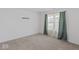 View of an empty bedroom featuring carpeted floors, white walls, and a window at 10107 Camp Creek Way, Indianapolis, IN 46229
