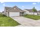 Charming single-story home featuring a two-car garage and a well-manicured lawn at 10107 Camp Creek Way, Indianapolis, IN 46229