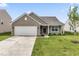 Charming single-story home featuring a two-car garage and a well-manicured lawn at 10107 Camp Creek Way, Indianapolis, IN 46229