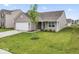 Charming single-story home featuring a two-car garage and a well-manicured lawn at 10107 Camp Creek Way, Indianapolis, IN 46229