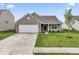 Charming single-story home with a well-maintained lawn and a two-car garage at 10107 Camp Creek Way, Indianapolis, IN 46229