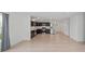 Modern kitchen with dark cabinets, stainless steel appliances, and wood-look flooring, seamlessly connecting to living area at 10107 Camp Creek Way, Indianapolis, IN 46229
