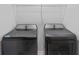 Modern laundry room with a front load washer and dryer, plus storage shelving at 10107 Camp Creek Way, Indianapolis, IN 46229