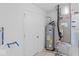 Utility room with water heater, furnace, plumbing and electrical components behind a white door at 10107 Camp Creek Way, Indianapolis, IN 46229