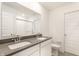 A bathroom with double sinks, quartz countertop and white cabinets at 10210 Samerton Ln, Indianapolis, IN 46239