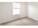 Neutral bedroom with carpet, a window with blinds, and white walls provides a blank canvas at 10210 Samerton Ln, Indianapolis, IN 46239