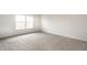 A simple bedroom with carpet, a window and white walls at 10210 Samerton Ln, Indianapolis, IN 46239