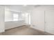 An upstairs bedroom with a window and a door at 10210 Samerton Ln, Indianapolis, IN 46239