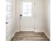 Bright entryway showcases a white front door, wood-look flooring, and neutral-toned walls at 10210 Samerton Ln, Indianapolis, IN 46239