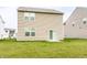Back exterior of home with siding, backyard, and a sliding glass door provides modern living at 10210 Samerton Ln, Indianapolis, IN 46239