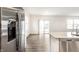 Bright kitchen features stainless steel appliances, a granite countertop, and hardwood style flooring at 10210 Samerton Ln, Indianapolis, IN 46239