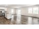 Open-concept living area with wood-look floors and abundant natural light at 10210 Samerton Ln, Indianapolis, IN 46239