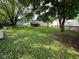 Expansive backyard with lush lawn, mature trees, and a deck, perfect for outdoor enjoyment at 10316 Woodhaven Cir, Indianapolis, IN 46229