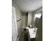 Well-lit bathroom features a shower, wood-look floors, and a modern vanity at 10316 Woodhaven Cir, Indianapolis, IN 46229