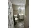 Cozy bathroom featuring a single sink vanity, toilet, and a neutral color scheme at 10316 Woodhaven Cir, Indianapolis, IN 46229