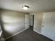 Bedroom with neutral walls, wood-look flooring, ceiling light, and closet at 10316 Woodhaven Cir, Indianapolis, IN 46229