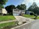 Split-level home featuring attached two-car garage and inviting front yard with mature landscaping at 10316 Woodhaven Cir, Indianapolis, IN 46229