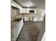 Bright kitchen featuring white cabinetry, granite countertops, stainless sink, and updated appliances at 10316 Woodhaven Cir, Indianapolis, IN 46229