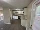Bright kitchen featuring white cabinetry, granite countertops, and stainless sink at 10316 Woodhaven Cir, Indianapolis, IN 46229