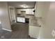 Bright kitchen featuring white cabinetry, granite countertops, stainless sink, and updated appliances at 10316 Woodhaven Cir, Indianapolis, IN 46229