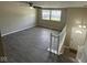 Spacious living room with new laminate floors, a ceiling fan, and natural light at 10316 Woodhaven Cir, Indianapolis, IN 46229