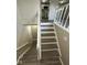 View of finished staircase with newel posts and gray wood grain steps at 10316 Woodhaven Cir, Indianapolis, IN 46229