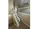 View of finished staircase with newel posts and gray wood grain steps at 10316 Woodhaven Cir, Indianapolis, IN 46229