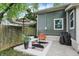 Backyard patio with privacy fence, seating, and an umbrella at 1046 N Hamilton Ave, Indianapolis, IN 46201
