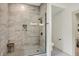 Walk-in shower with glass enclosure and light tile walls and decorative tile floor at 1046 N Hamilton Ave, Indianapolis, IN 46201