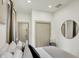 Neutral bedroom with a circular mirror on the wall, closet and hardwood floors at 1046 N Hamilton Ave, Indianapolis, IN 46201