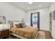 This bedroom features a neutral color scheme, dark hardwood floors, and a window with natural light at 1046 N Hamilton Ave, Indianapolis, IN 46201