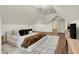 Cozy bedroom with a neutral color palette, a geometric rug, and a modern chandelier at 1046 N Hamilton Ave, Indianapolis, IN 46201