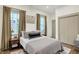 Cozy bedroom with neutral tones, bedside tables, and windows with natural light at 1046 N Hamilton Ave, Indianapolis, IN 46201