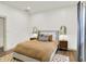 This bedroom features a neutral color scheme, hardwood floors, and bedside tables at 1046 N Hamilton Ave, Indianapolis, IN 46201